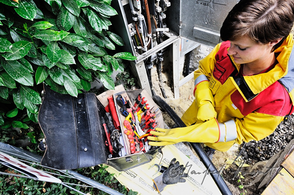 woman electrician installing a power connector
