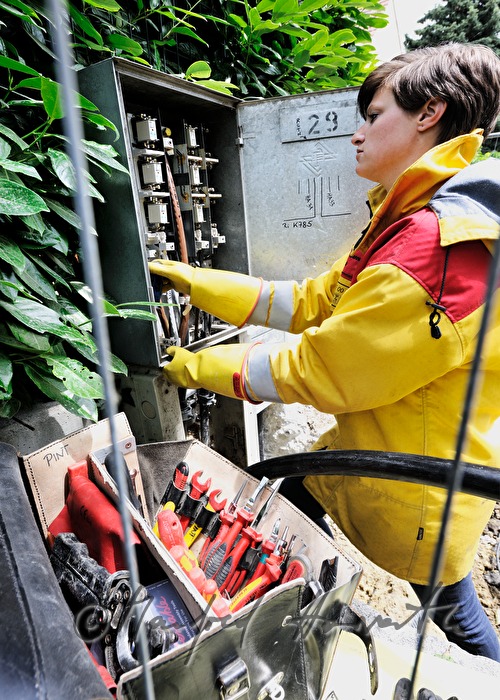 woman electrician installing a power connector