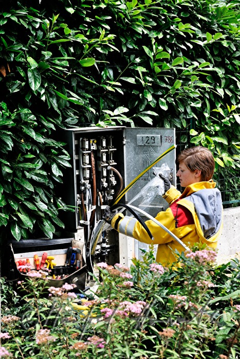 woman electrician installing a power connector