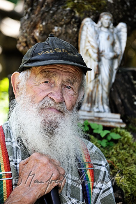 farmer on the bench in front of his house
