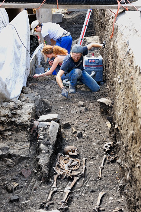 archaeologists uncovering a medieval cemetery