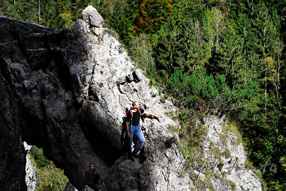 hiker climbing a rock near the Lassingfall