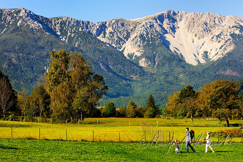 family with son hiking in the alps