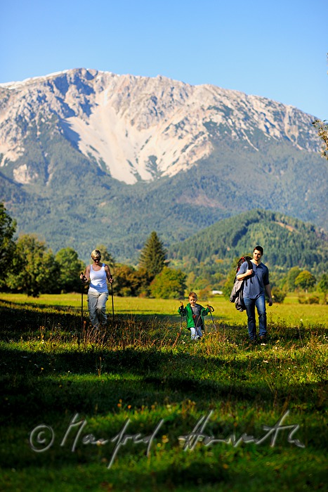 family with son hiking in the alps