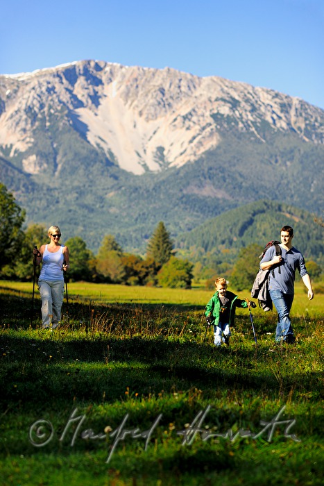 family with son hiking in the alps