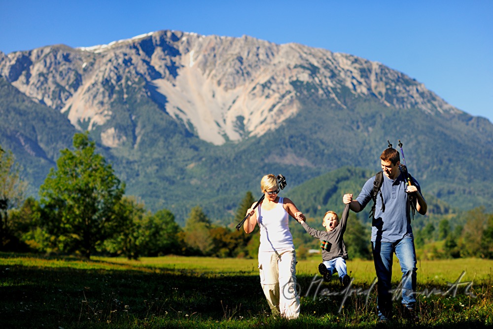 family with son hiking in the alps