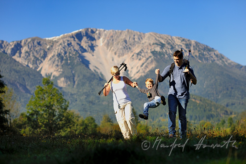 family with son hiking in the alps
