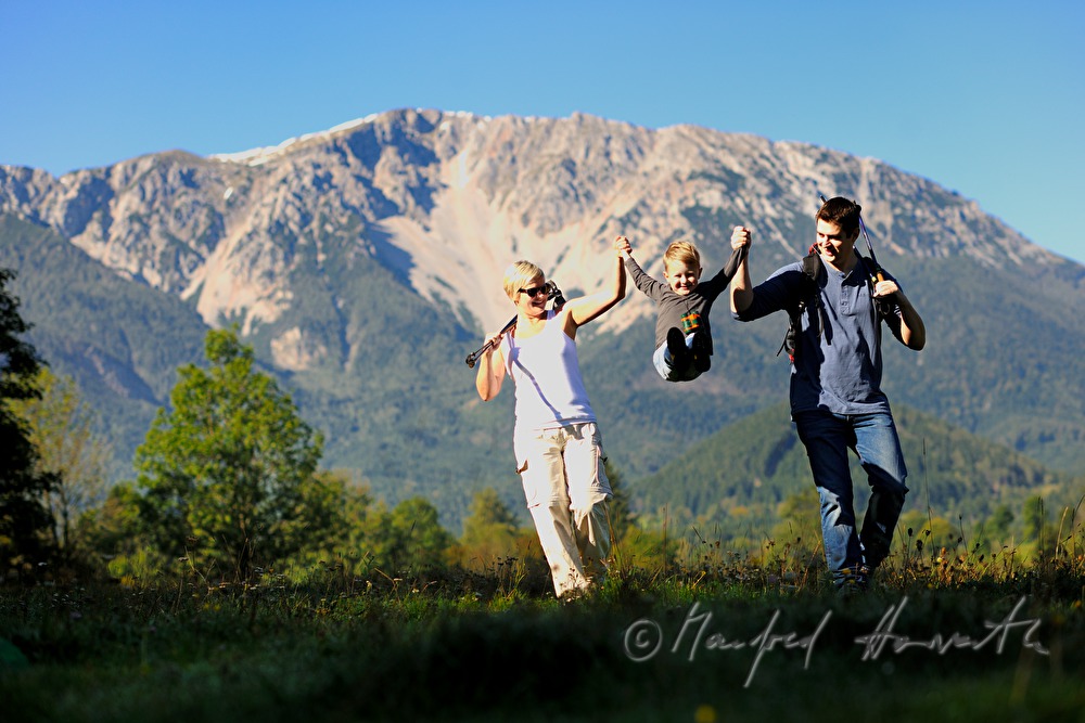 family with son hiking in the alps