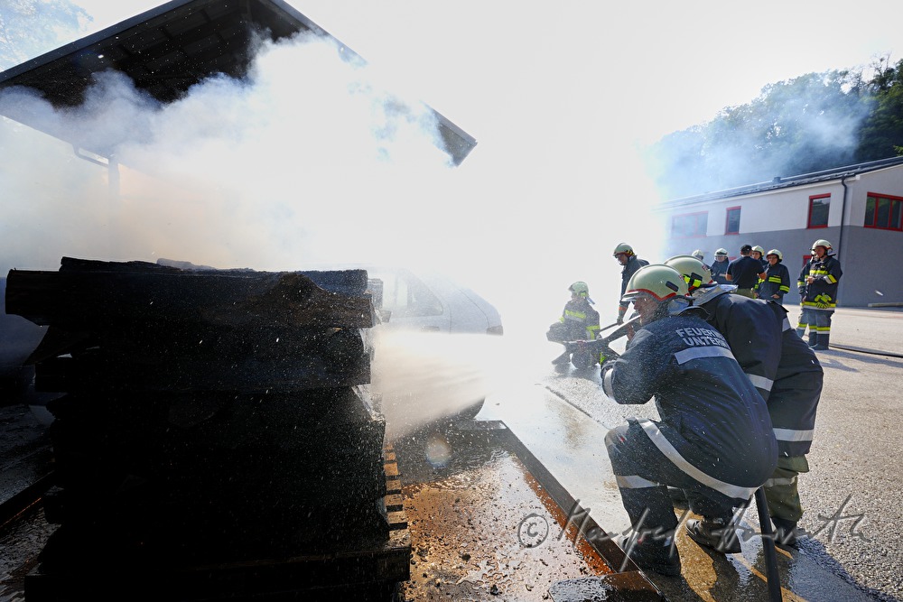 fireman distinguishing a burning car for training