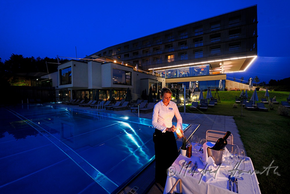 waitress sets the table near the pool