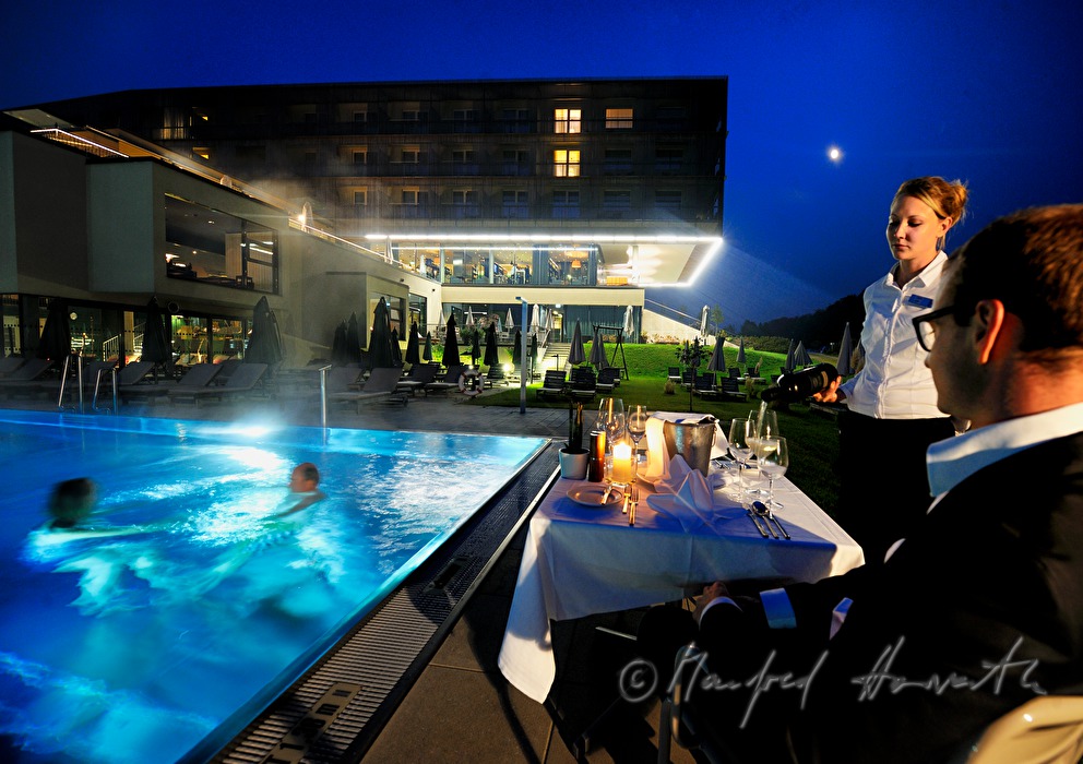 waitress sets the table near the pool