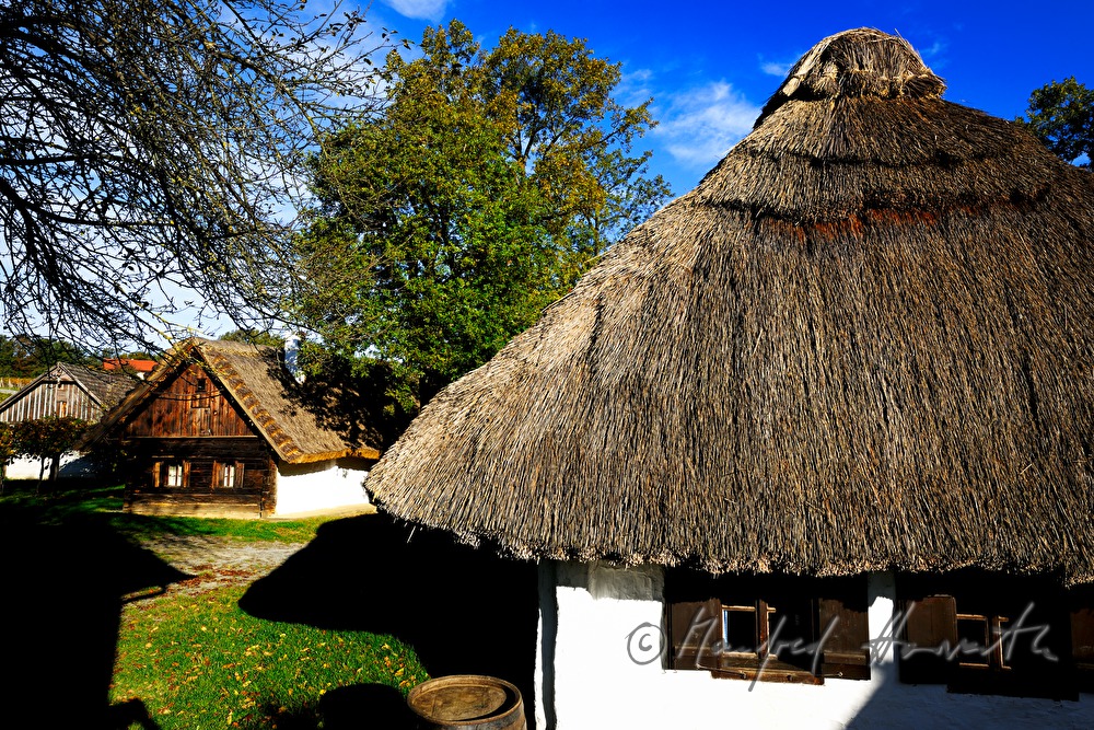 mud-walled wine cellars with tatched roofs