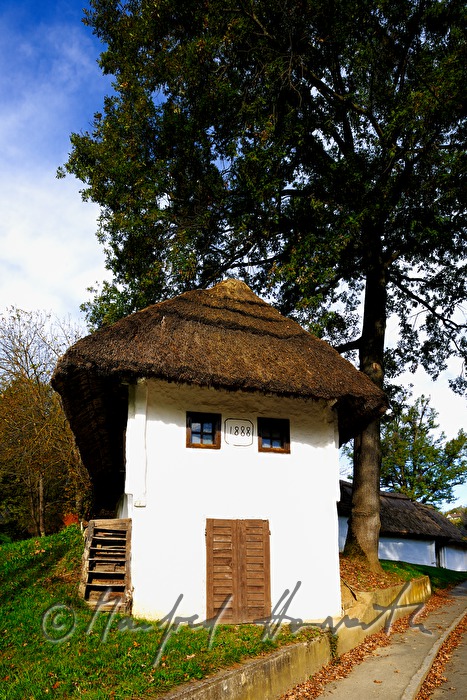 mud-walled wine cellars with tatched roofs
