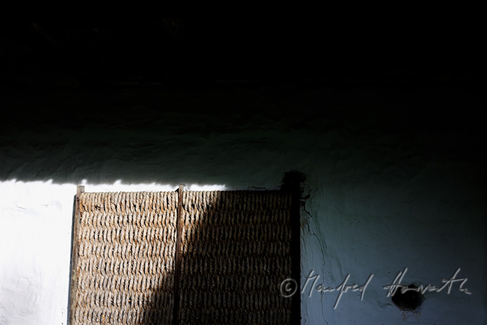 mud-walled wine cellar with thatched roof