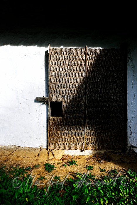 mud-walled wine cellar with thatched roof