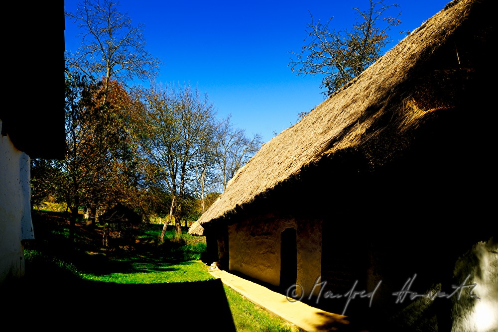 mud-walled wine cellar with thatched roof