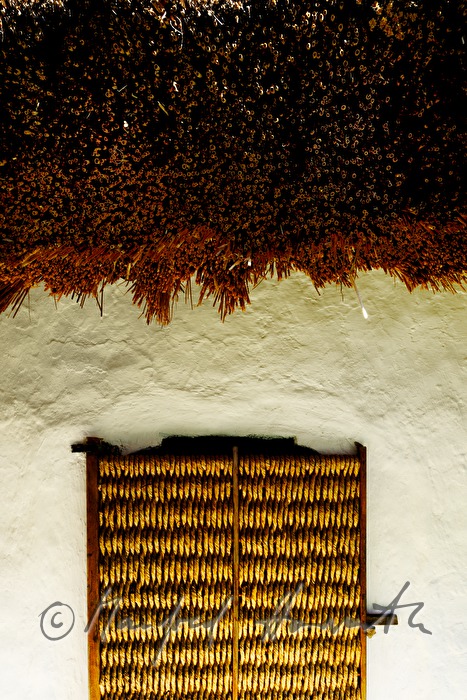 mud-walled wine cellar with thatched roof