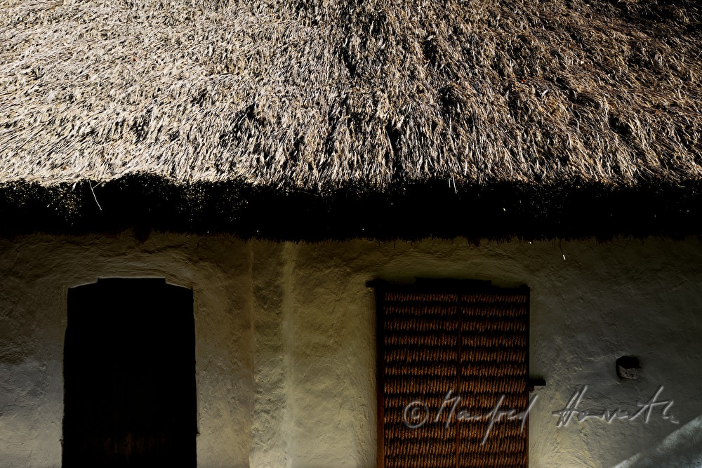 mud-walled wine cellars with tatched roofs