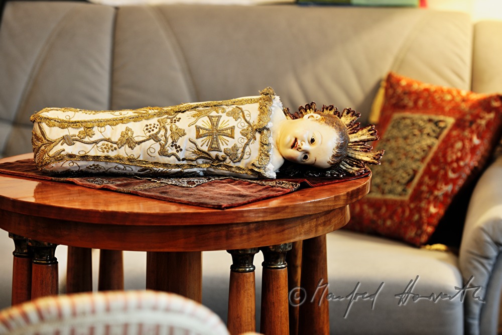 swaddled new born Christ dressed in brocade