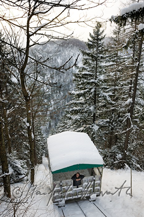 worker of the hydraulic power station rides the inclined lift