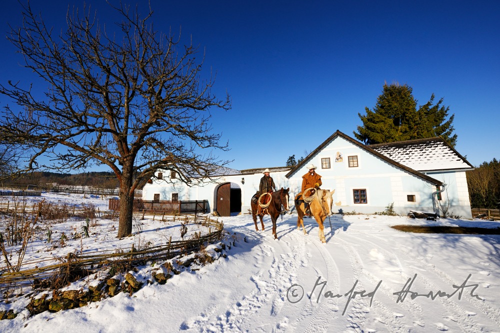 operators of the Ranch riding near their farm house
