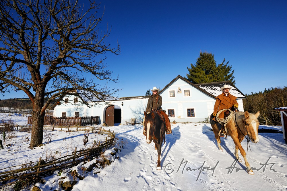 operators of the Ranch riding near their farm house