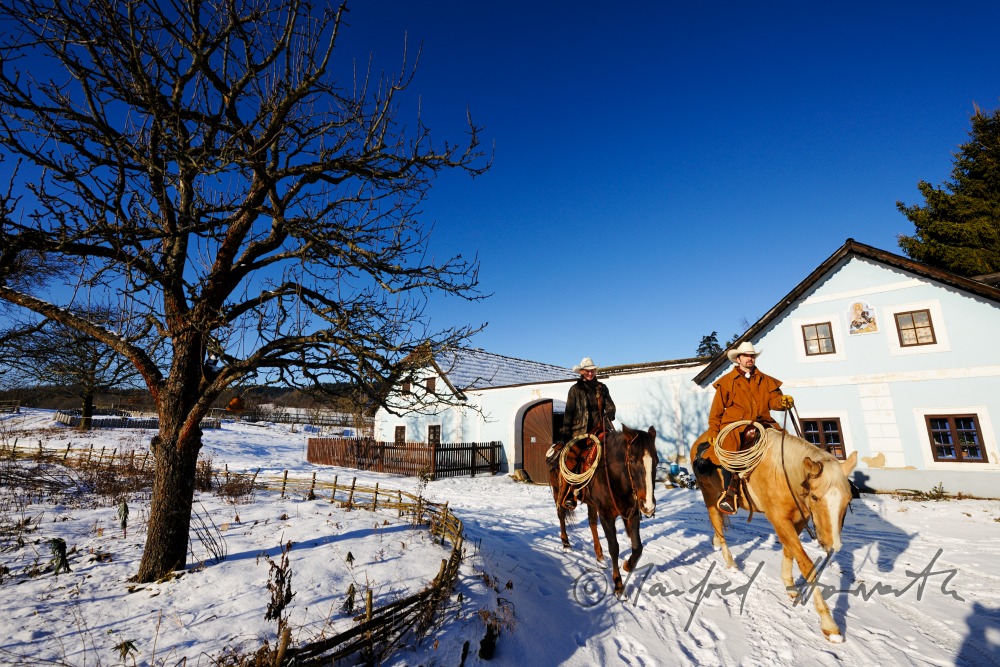 operators of the Ranch riding near their farm house
