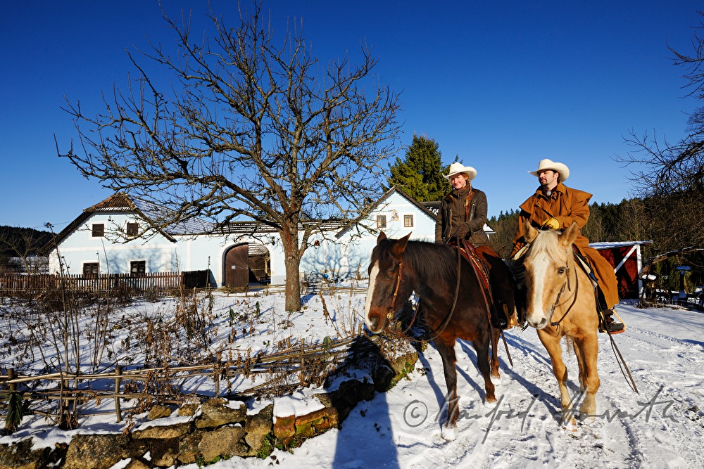 operators of the Ranch riding near their farm house