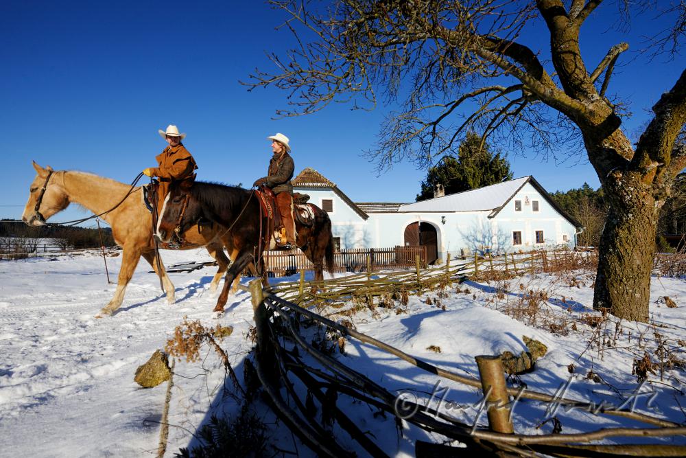 operators of the Ranch riding near their farm house