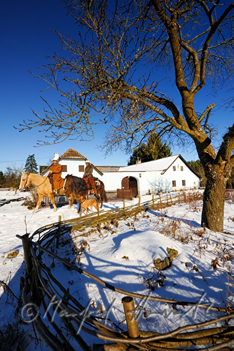 operators of the Ranch riding near their farm house