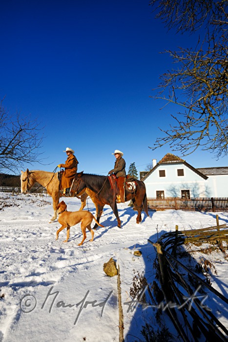 operators of the Ranch riding near their farm house