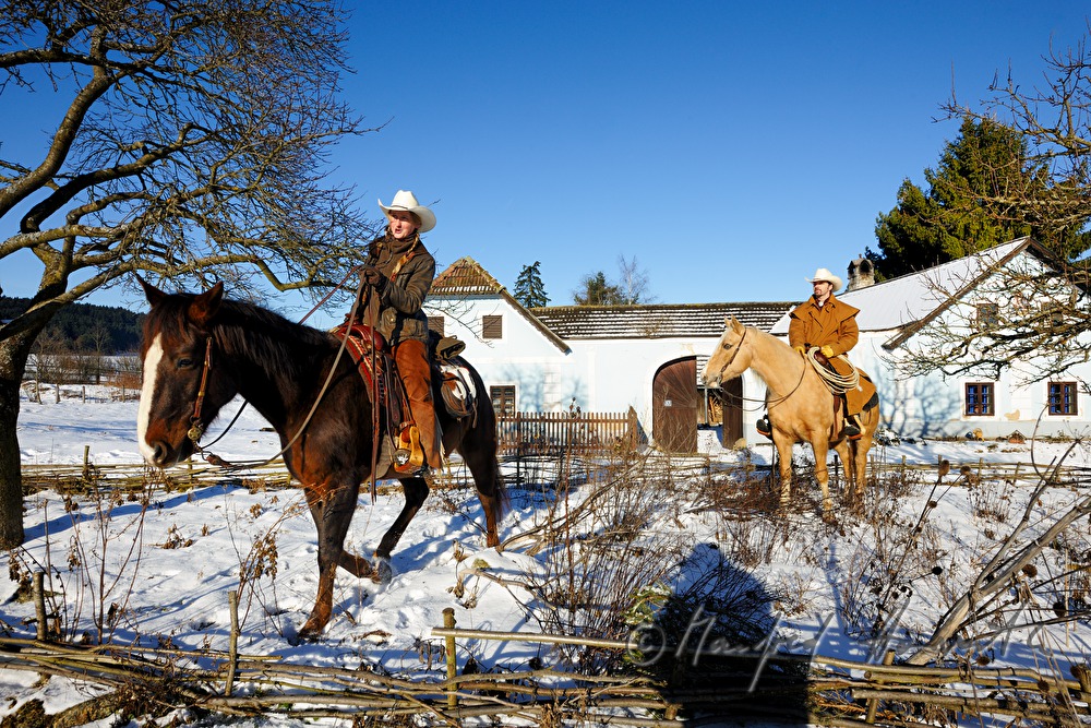 operators of the Ranch riding near their farm house