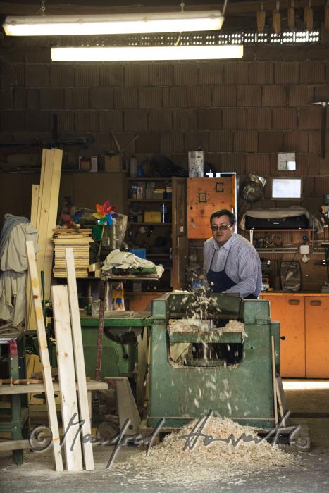 hobby horse carpenter planing wood in his workshop