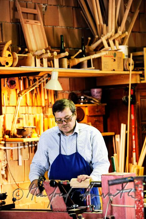hobby horse carpenter in his workshop working on the turning lathe