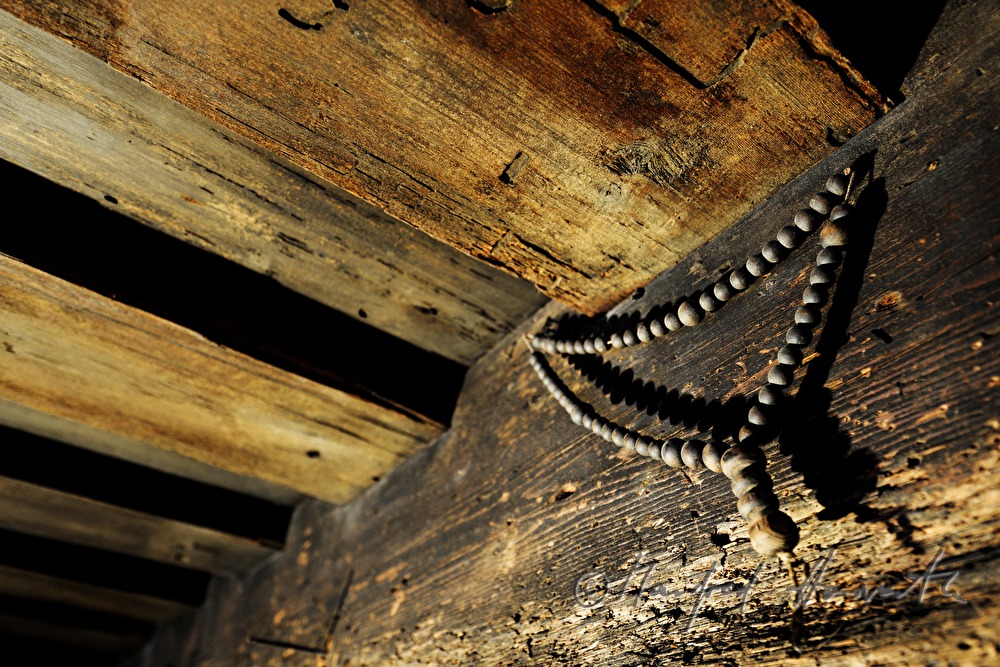 old rosary on a tram of the wooden ceiling