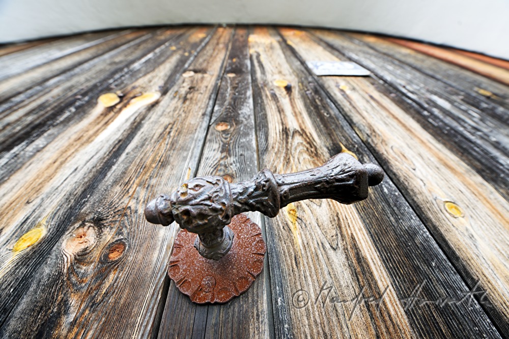 door knob of a wooden gate of a farm house in the village
