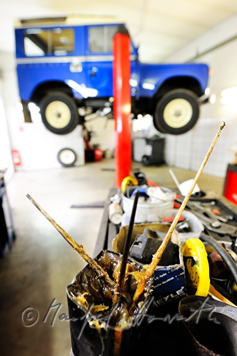 grease in a pot and a Land Rover on the hydraulic ramp