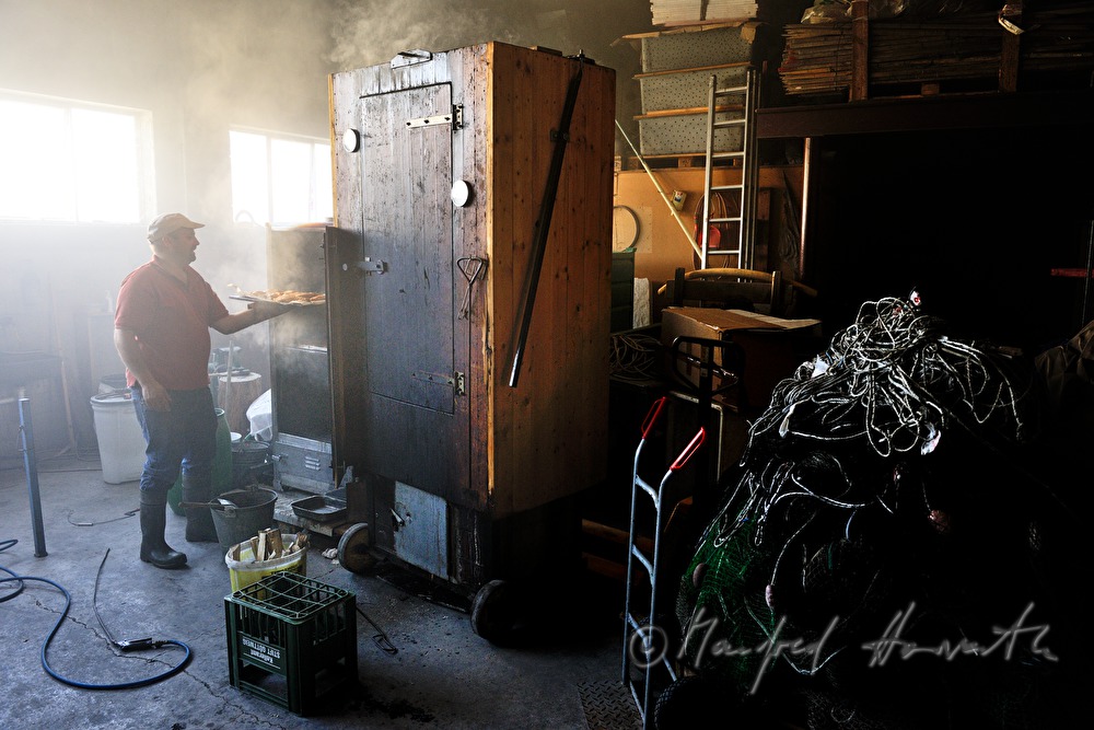 fisherman smokes eels in a smoke chamber