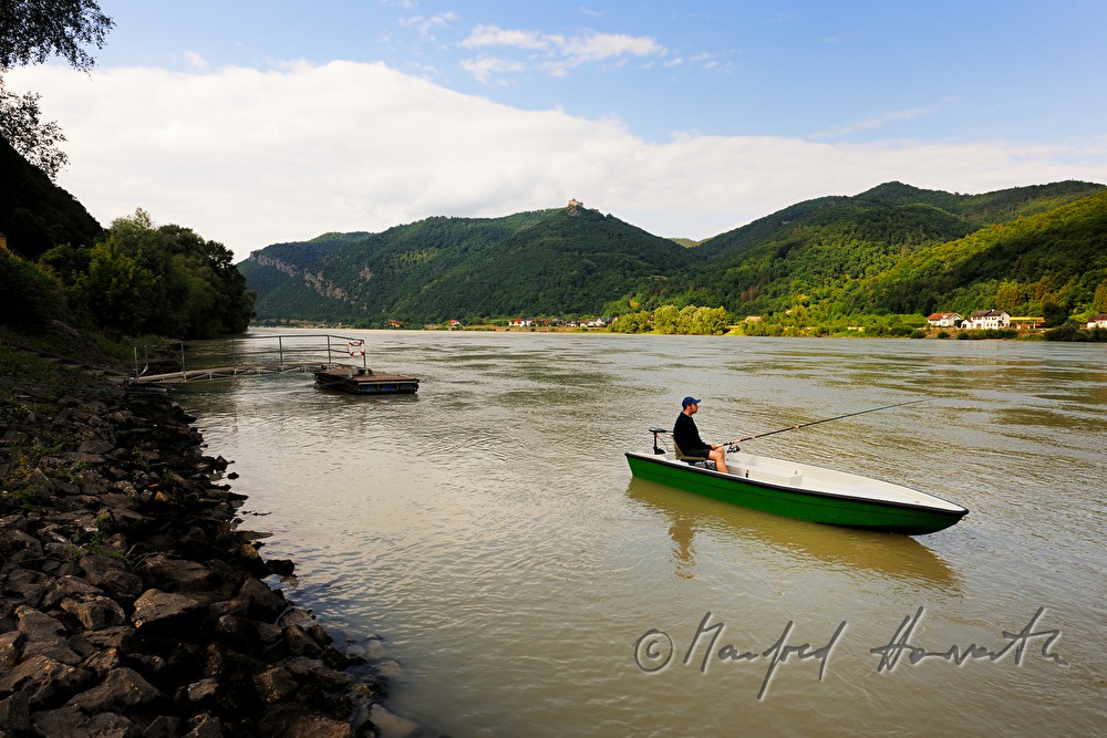 fisherman on the river shore of the Danube