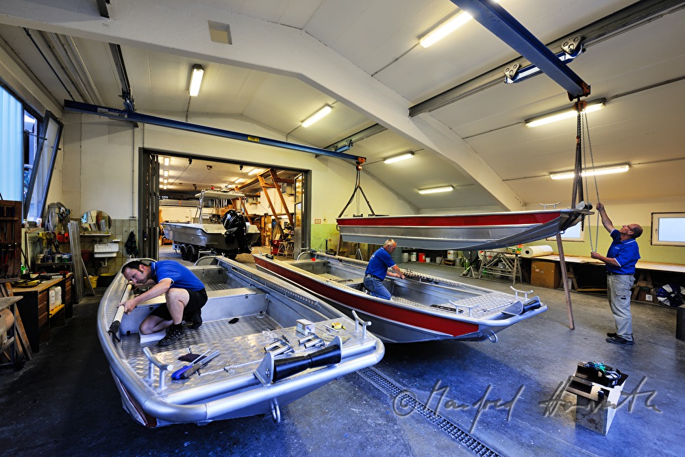 workers of the wharf building boats made of aluminium