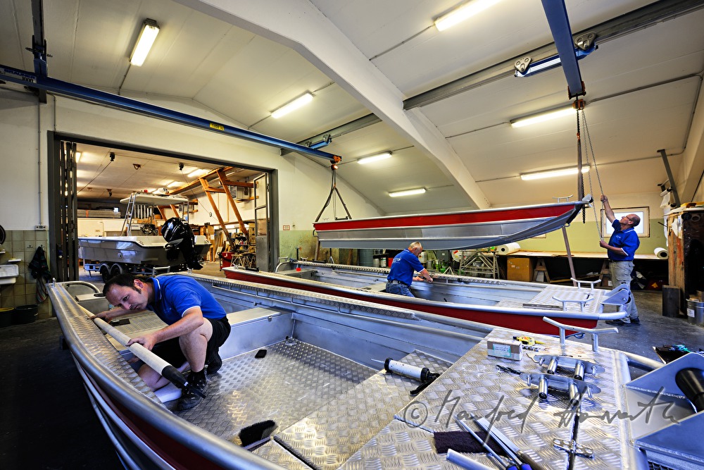 workers of the wharf building boats made of aluminium