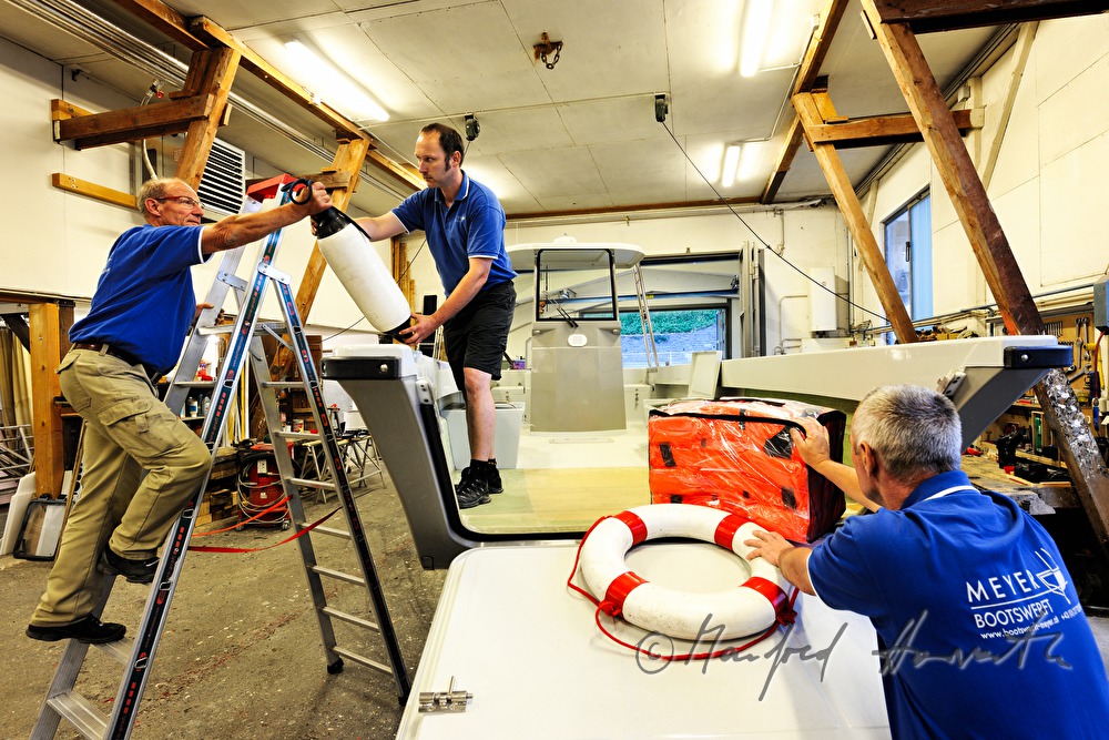 workers of the wharf building work boats made of plastic