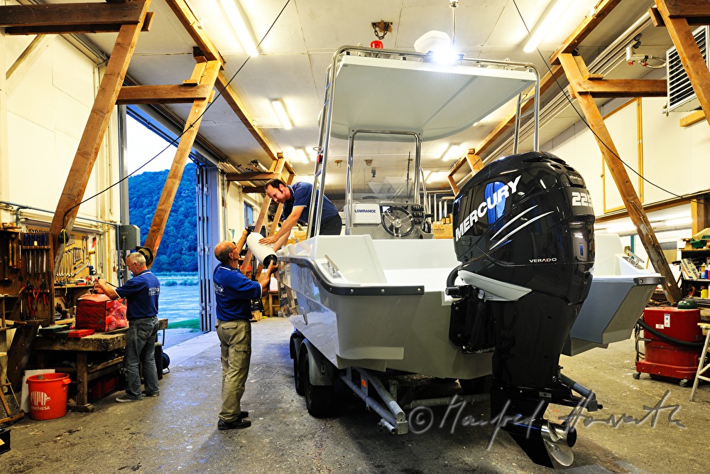 workers of the wharf building work boats made of plastic