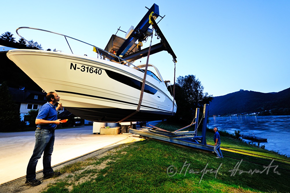 landing a motor yacht on the water with a crane