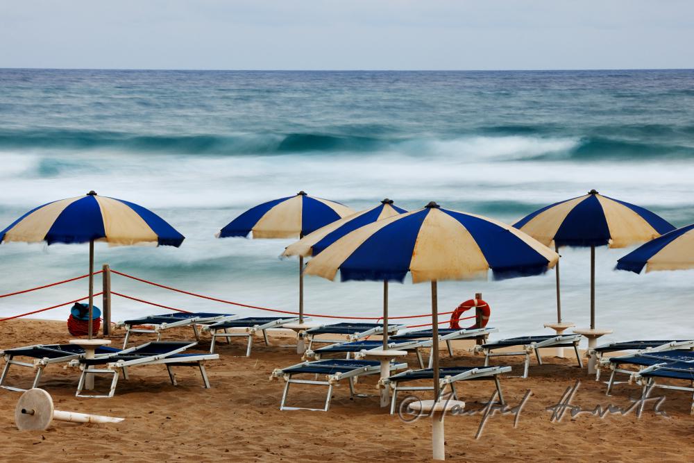 sun umbrellas and rolling waves