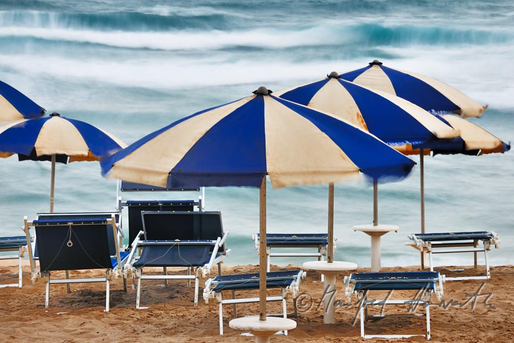 sun umbrellas and rolling waves