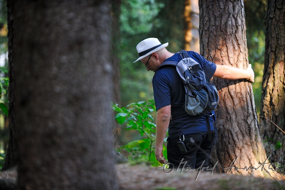 geocacher at the place of finding the geocache