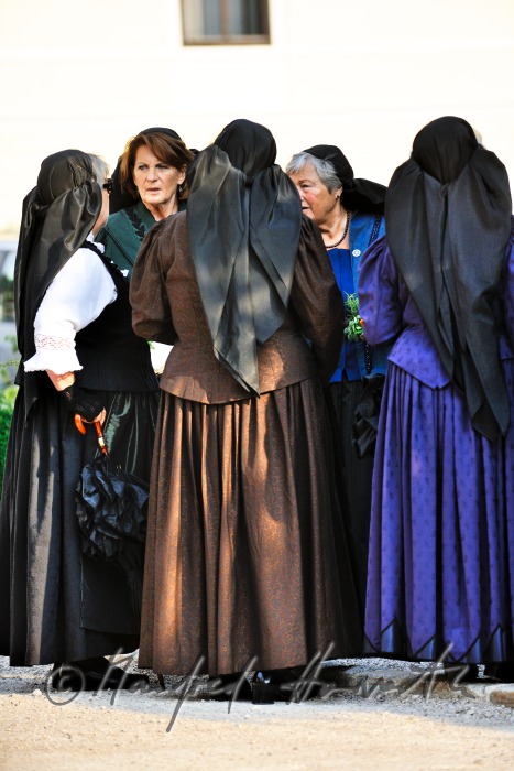 women in traditional clothes near the church