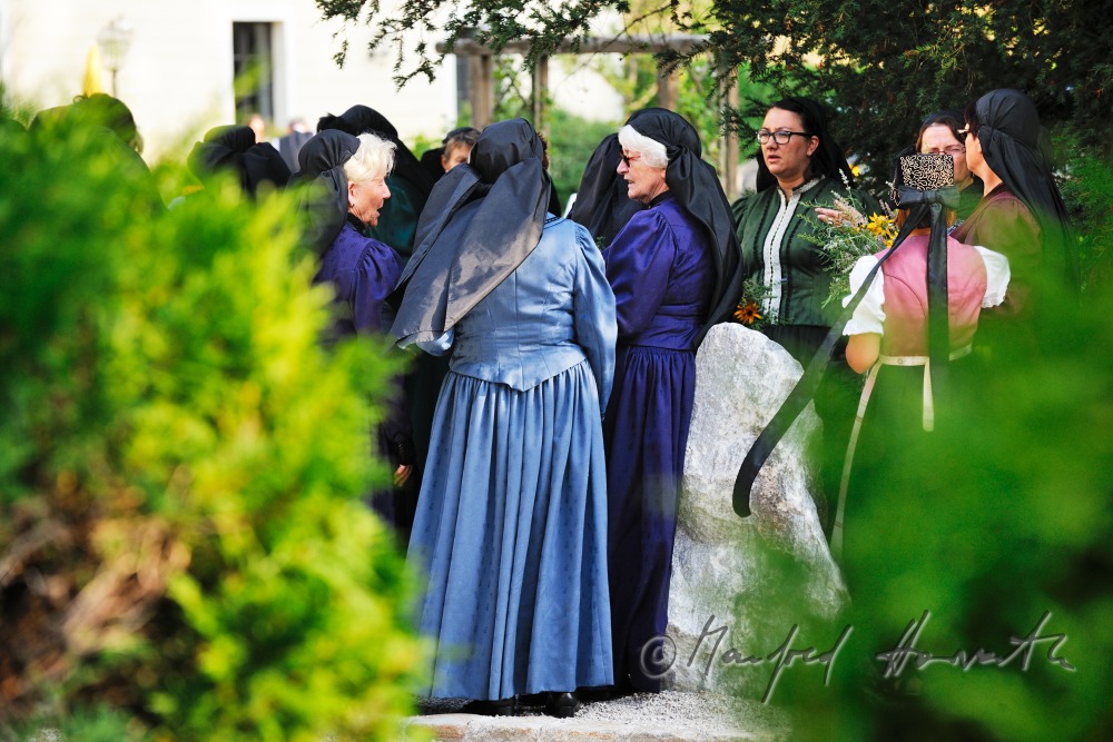 women in traditional clothes near the church