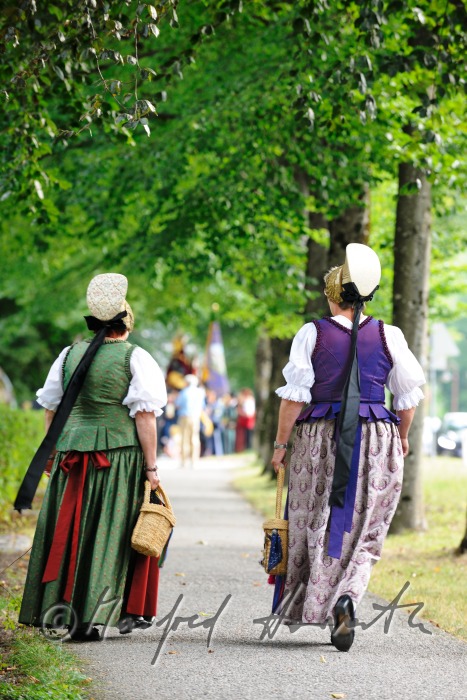 women in traditional clothes on the way to church